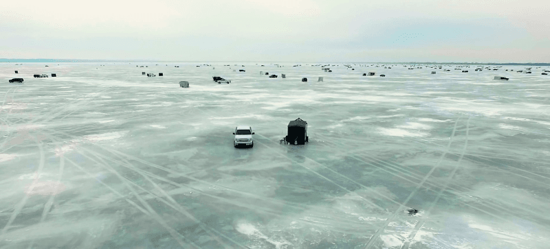 trucks and shantys on frozen Lake Winnebago