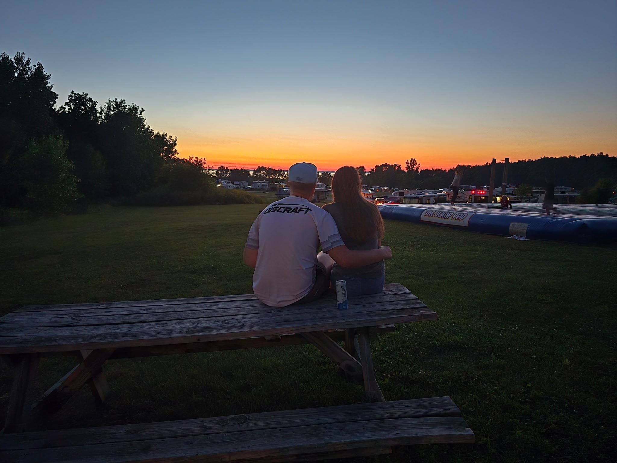 Couple enjoying early fall sunset at campground